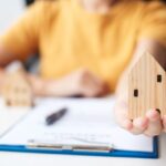 Documents d’assurance habitation posés sur un bureau avec un stylo et une calculatrice.